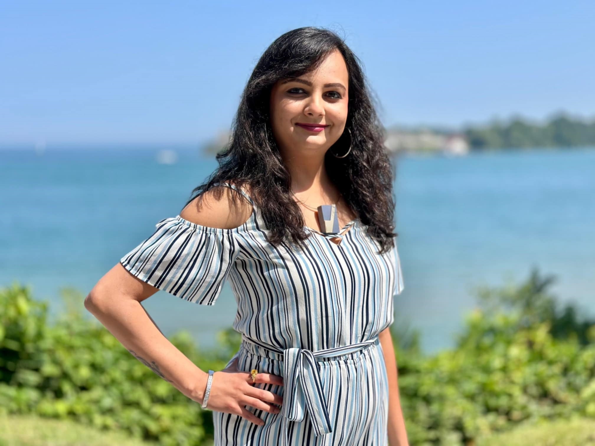 Shivani Patel, online therapist, smiling by the water, representing warmth, support, and compassionate mental health care.